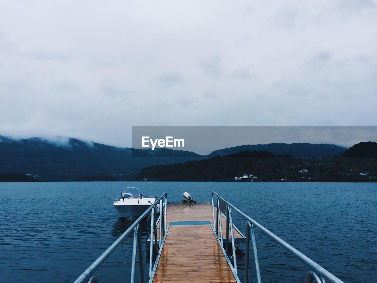 Pier over lake against sky