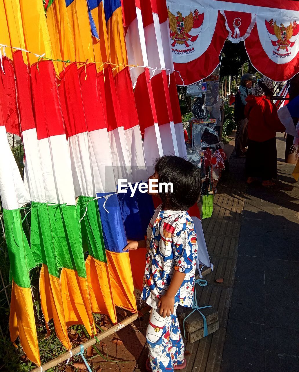 Side view of girl looking at colorful decorations