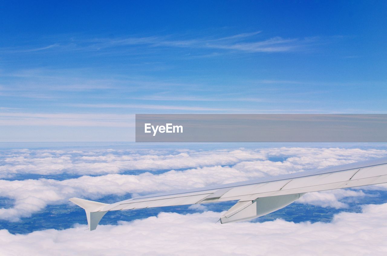 Airplane wing against blue sky