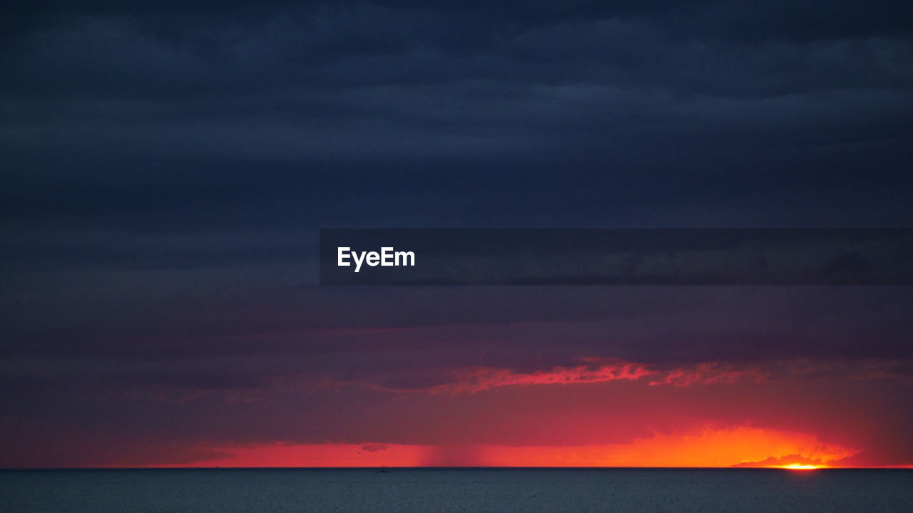 Scenic view of dramatic sky over sea
