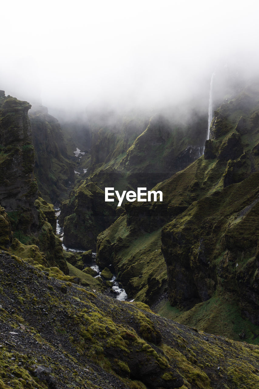 SCENIC VIEW OF LANDSCAPE AND MOUNTAINS AGAINST SKY