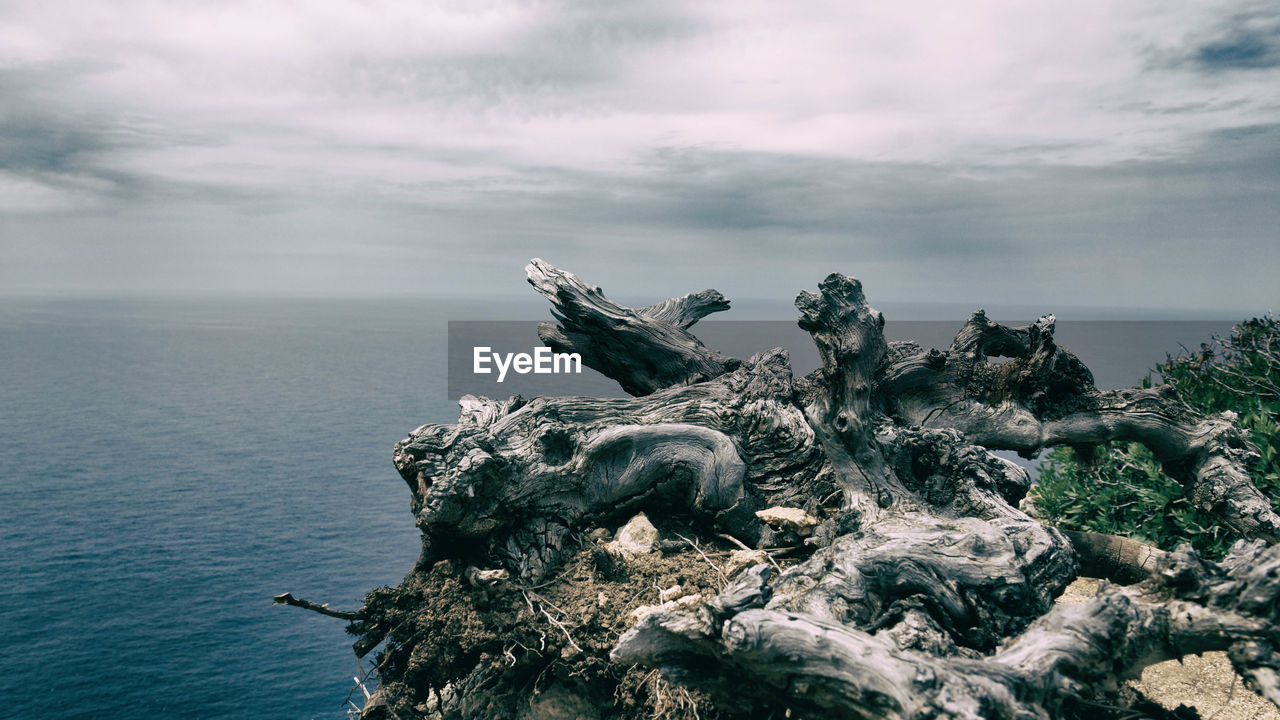 Scenic view of sea against cloudy sky