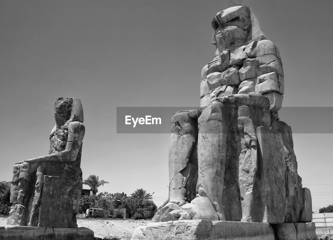Low angle view of statue against sky - colossi of memnon