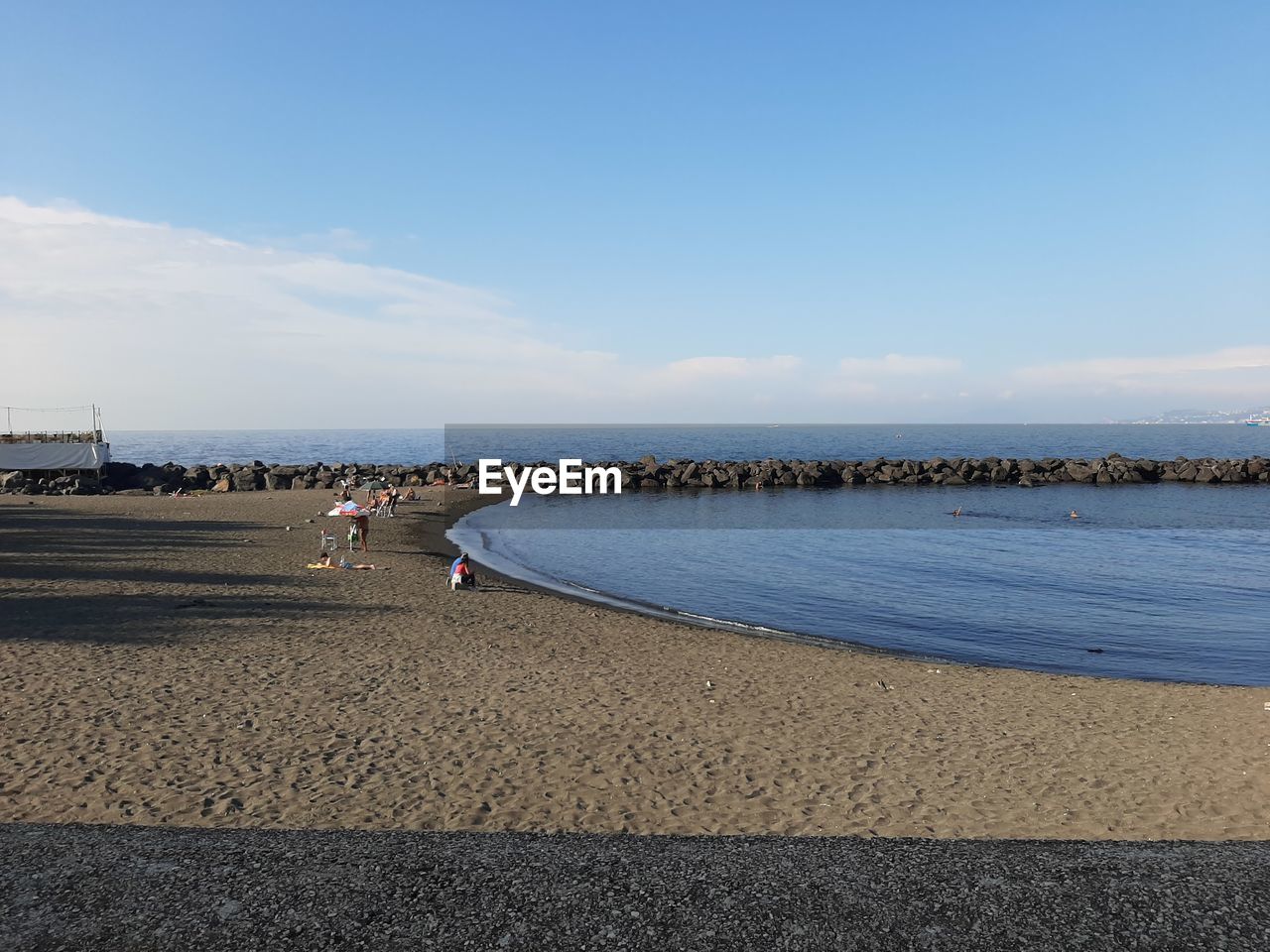 PEOPLE ON BEACH AGAINST SKY