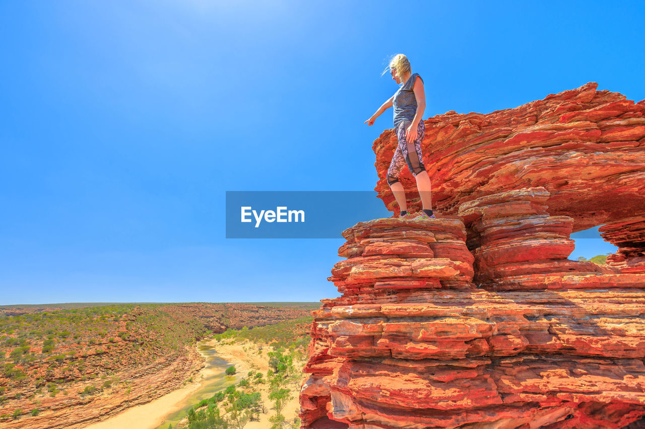 Woman standing on rock formation at kalbarri national park 