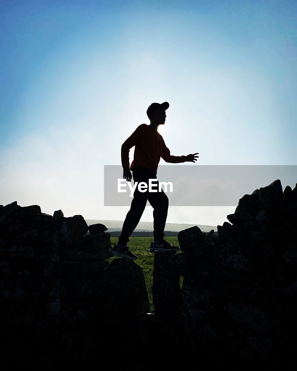 rear view of man standing on rock