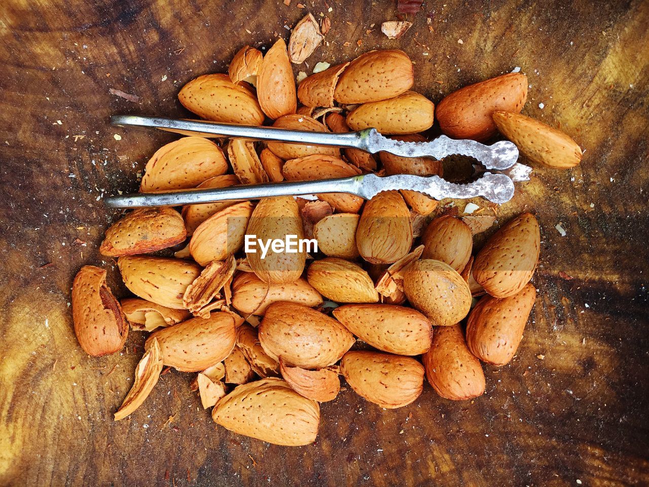 Close-up of almond shells and nutcracker