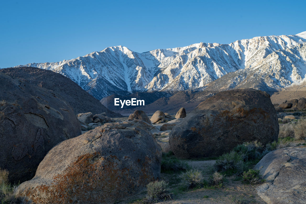 Scenic view of snowcapped mountains against clear sky