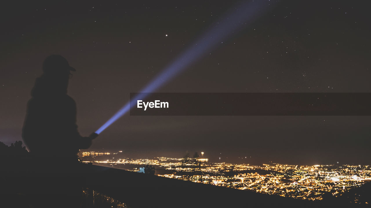 AERIAL VIEW OF ILLUMINATED CITY AT NIGHT