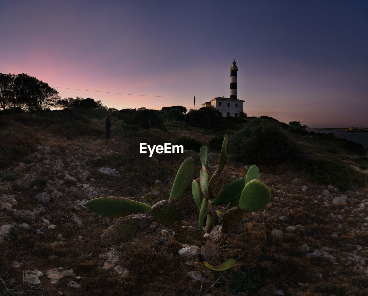 scenic view of lighthouse against sky during sunset