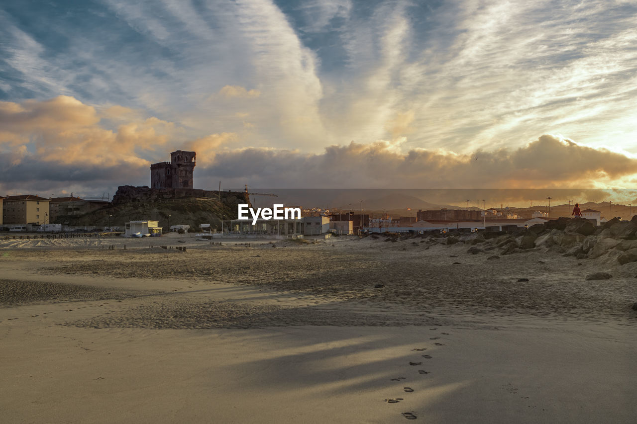 Scenic view of beach against sky during sunset