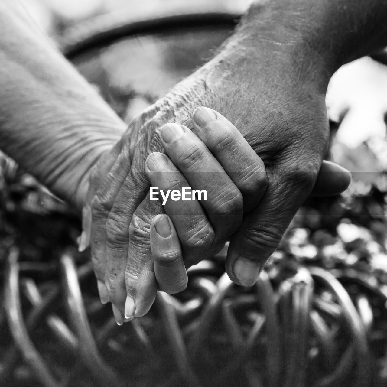 Cropped image of senior couple with holding hands