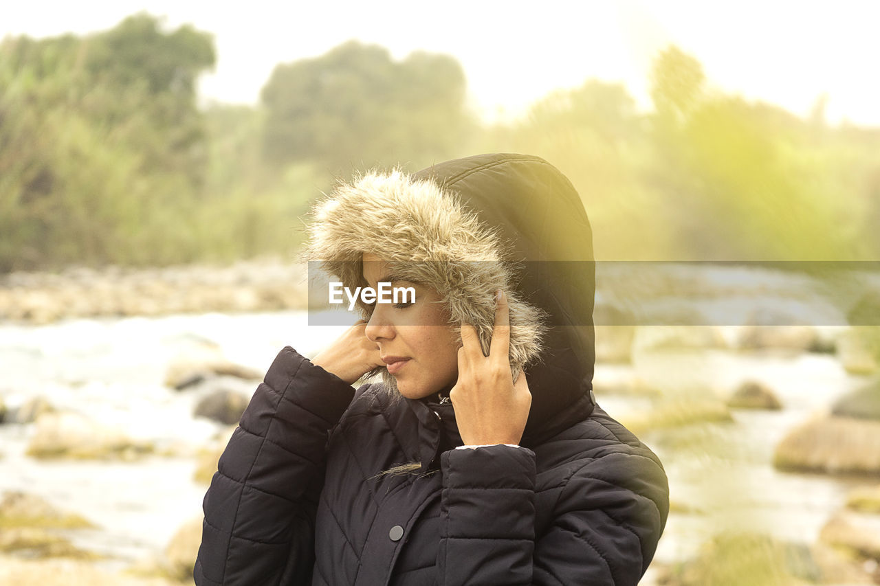 Portrait of young woman standing in snow