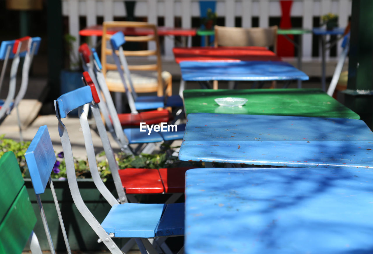 Chairs arranged by table at sidewalk cafe