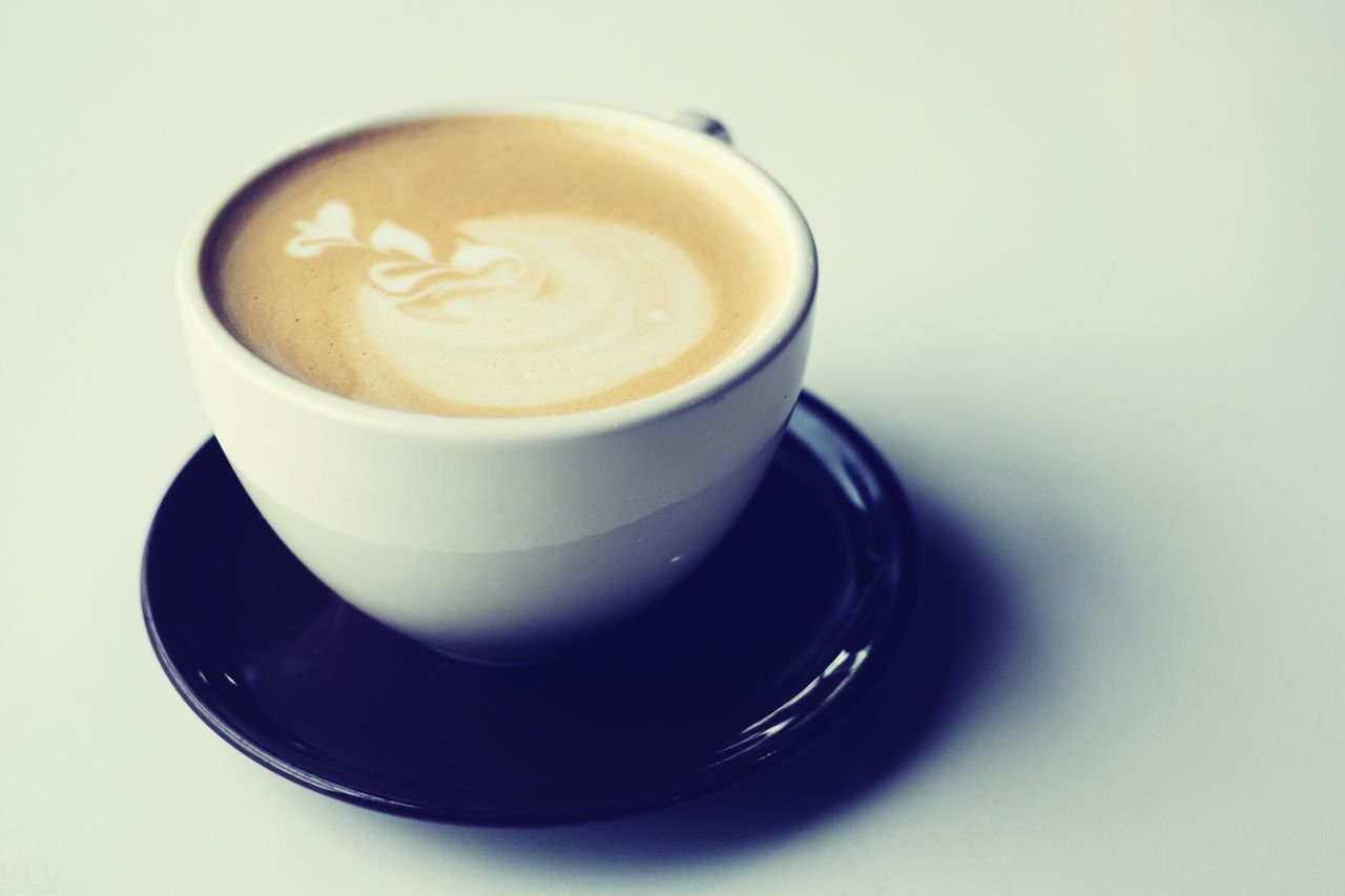 Close-up of coffee cup on white background