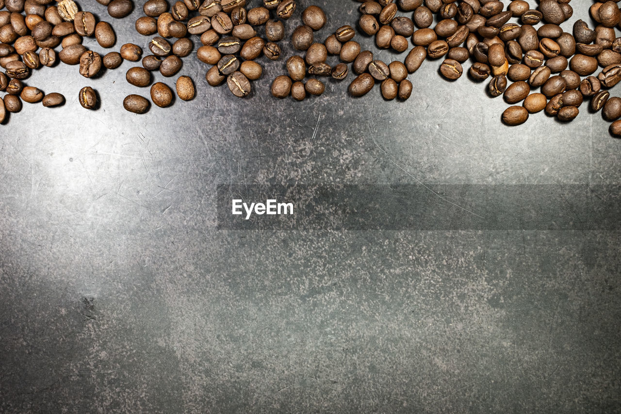 HIGH ANGLE VIEW OF COFFEE BEANS ON GLASS