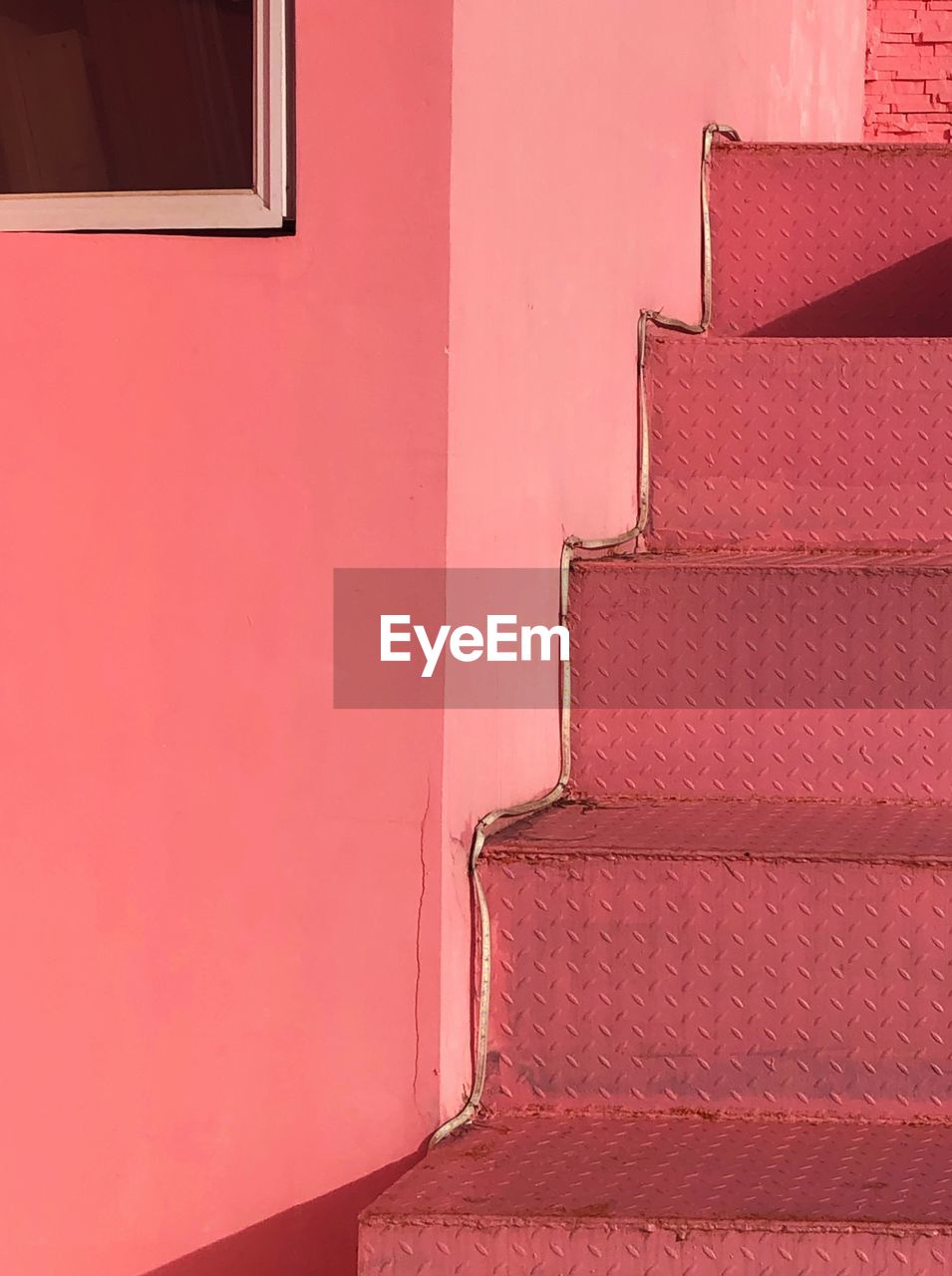CLOSE-UP OF WINDOW ON PINK WALL
