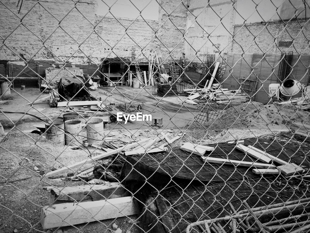 FISHING NET IN CAGE SEEN THROUGH CHAINLINK FENCE IN ZOO