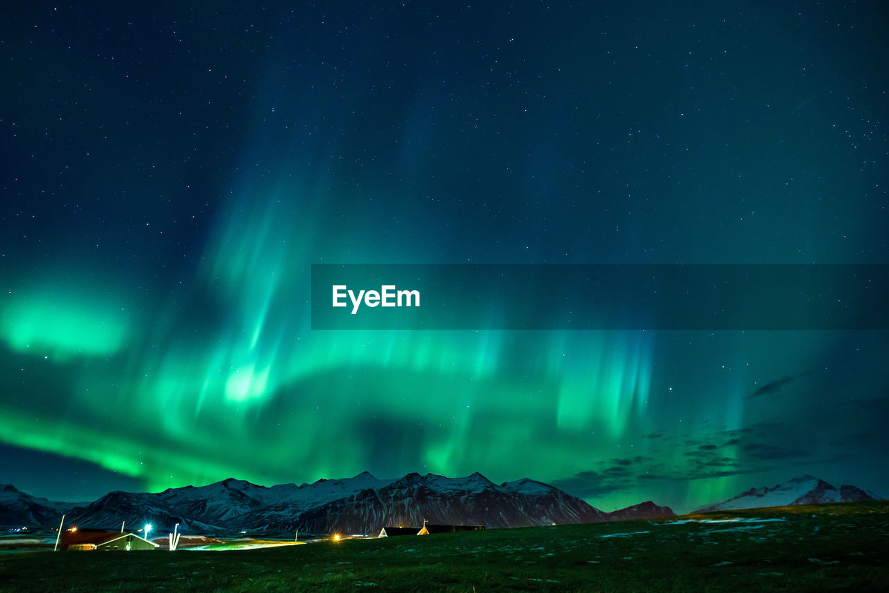 Scenic view of snowcapped mountains against sky at night