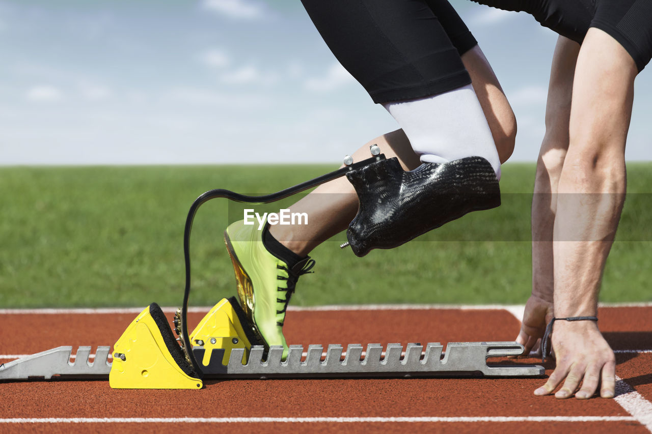 Low section of man on running track