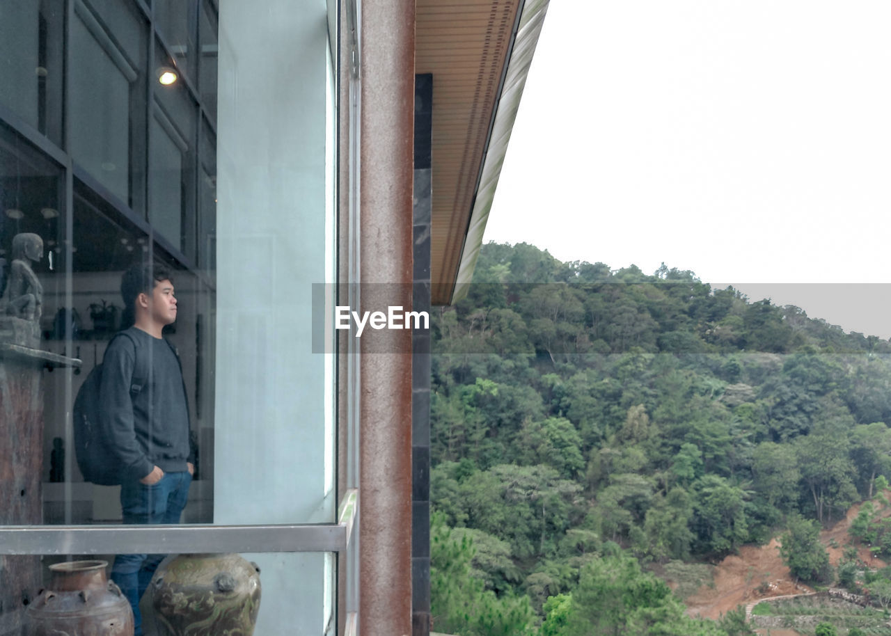 Man standing by window in building