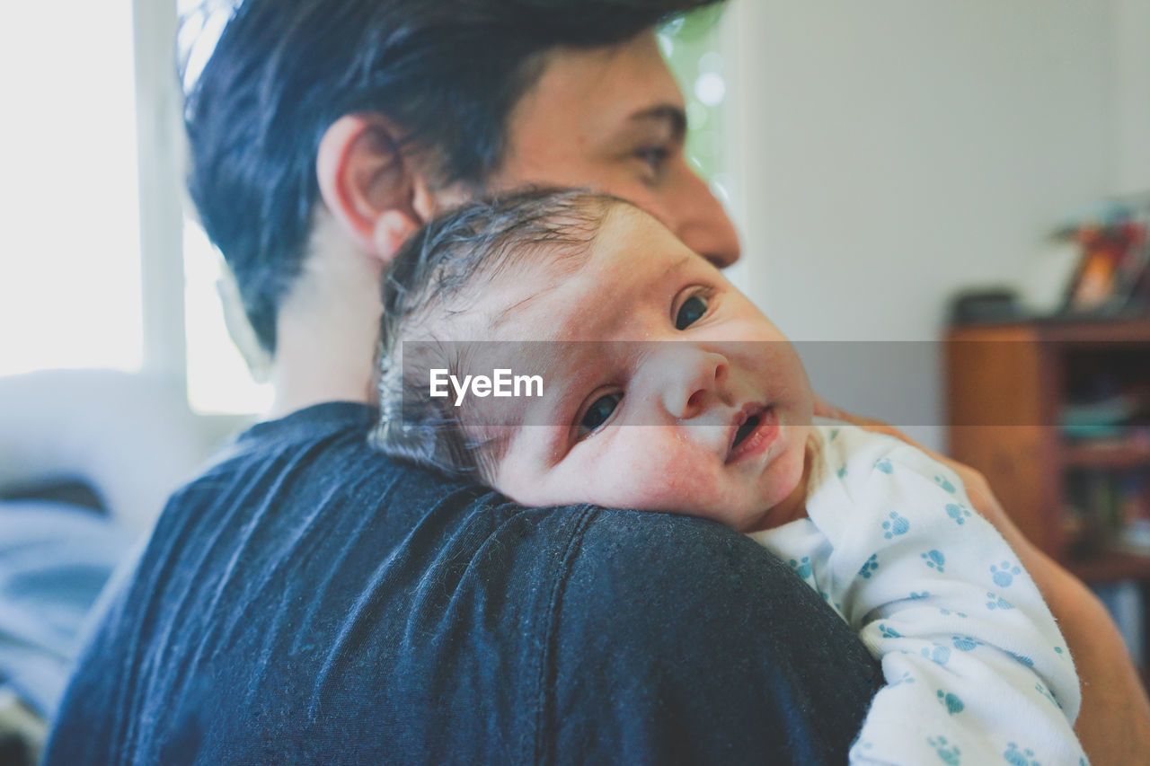 Portrait of father with baby at home