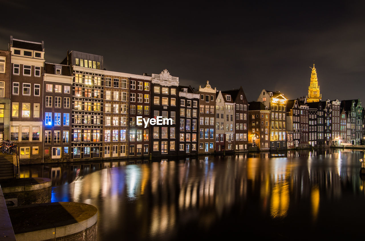 Reflection of illuminated buildings in city at night