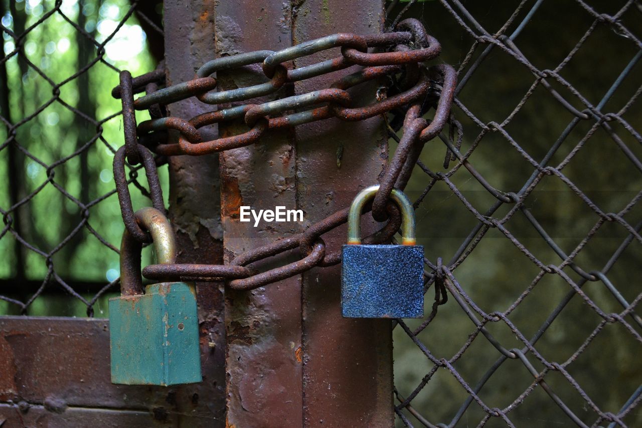 Close-up of padlock on metal grate