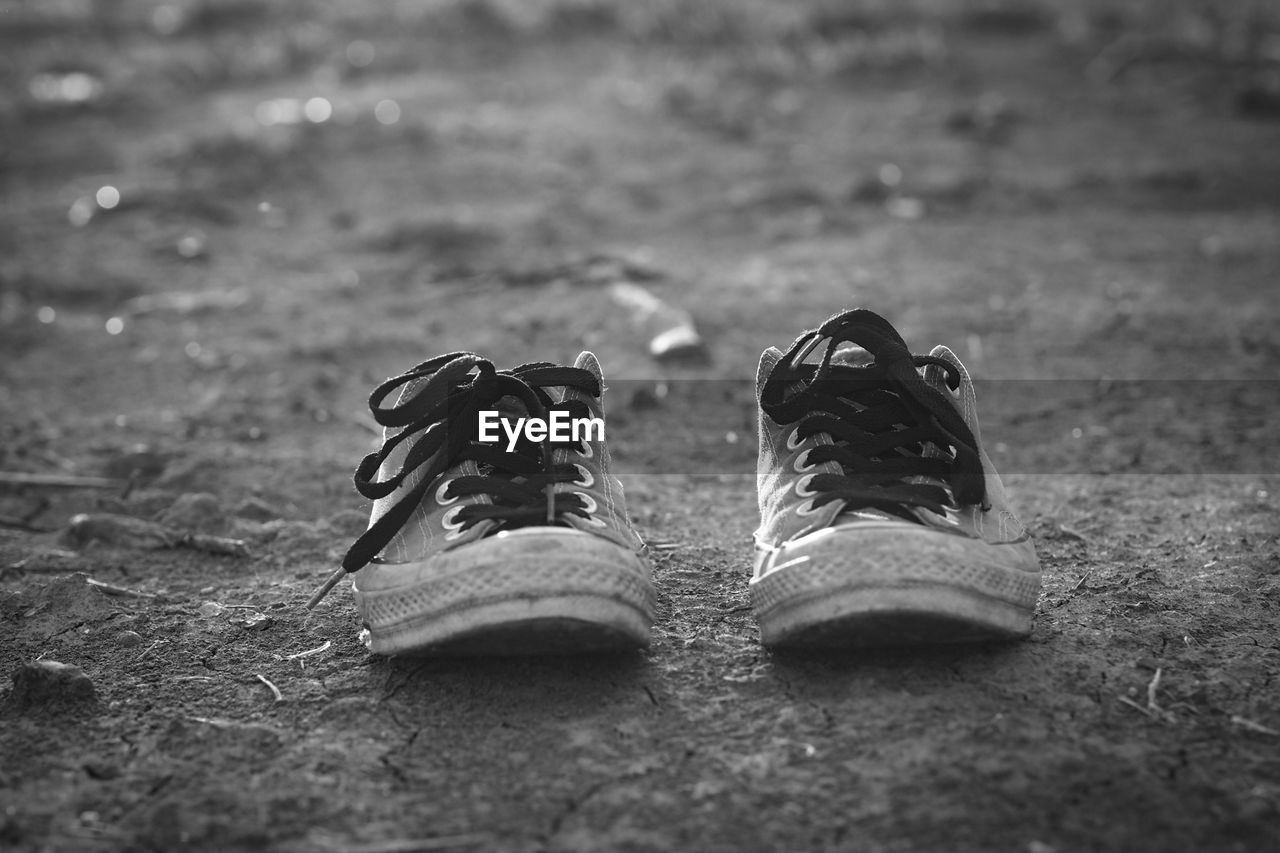 Close-up of shoes on field