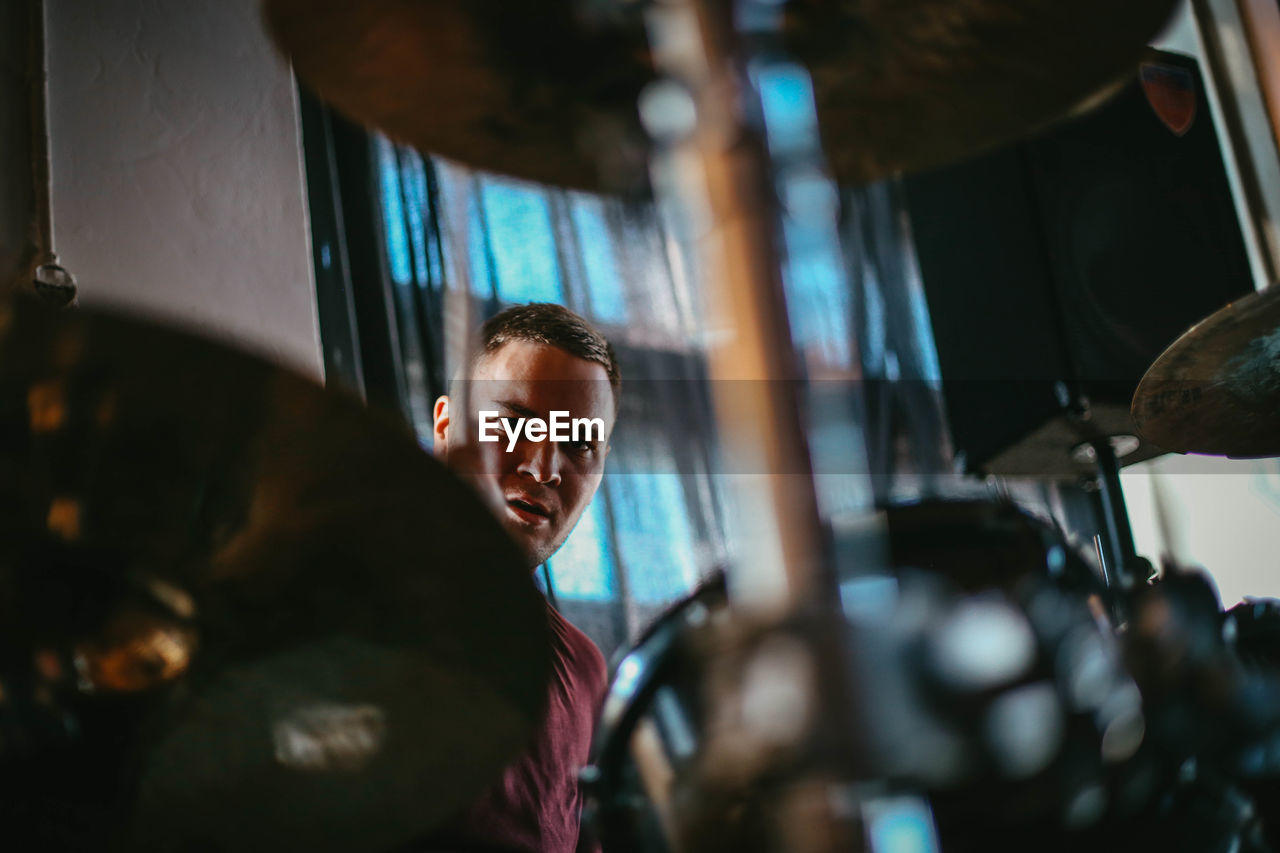 Portrait of man playing drum in concert