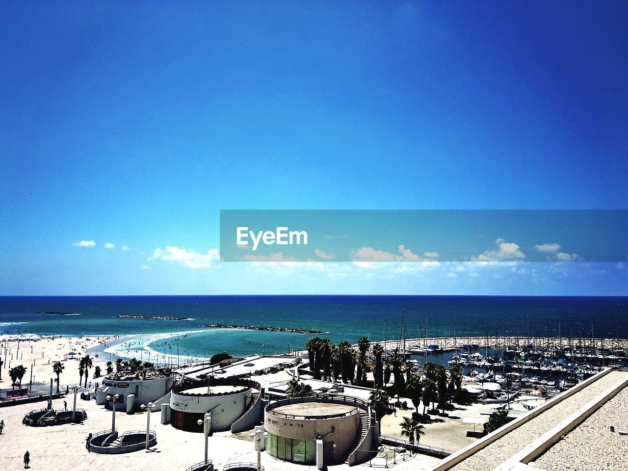 Scenic view of beach against blue sky