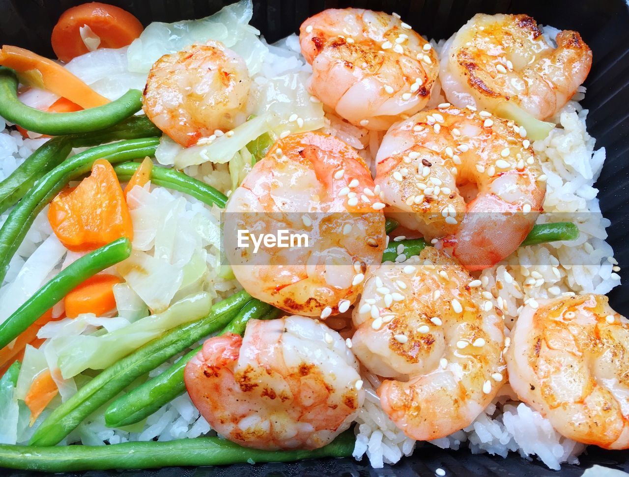 High angle view of prawns with rice in box