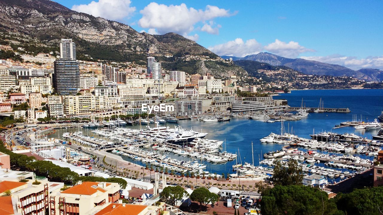 High angle view of cityscape by sea against sky