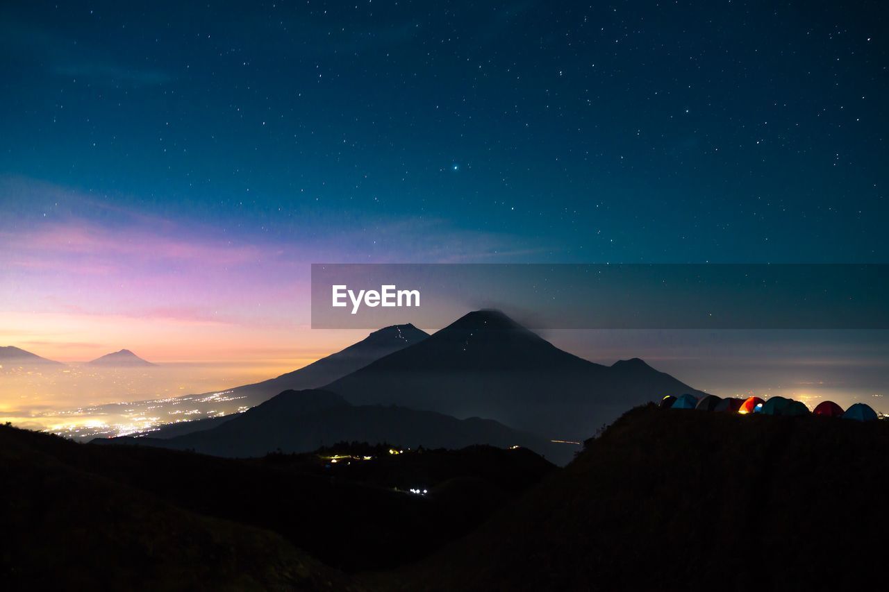 Scenic view of mountains against sky at night