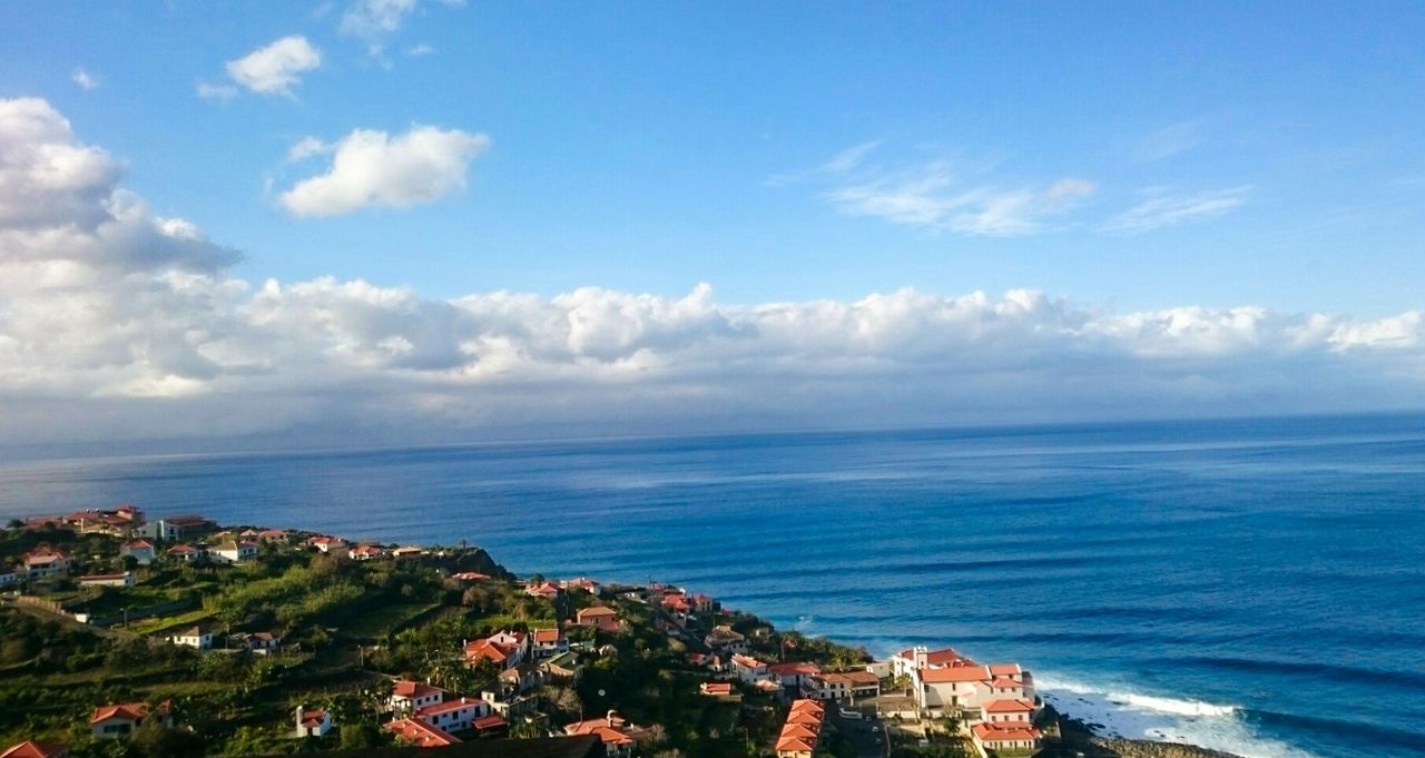 Scenic view of land and sea against sky