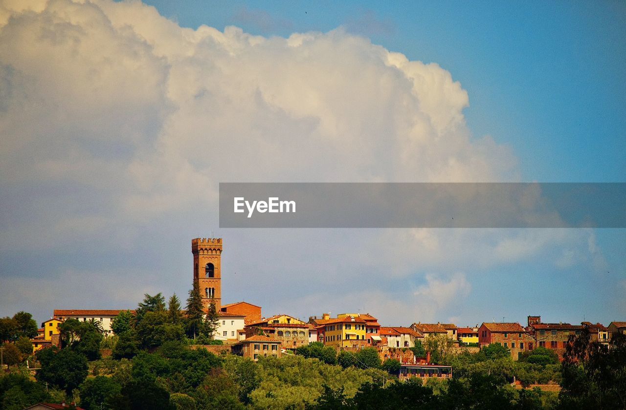 Village against cloudy sky