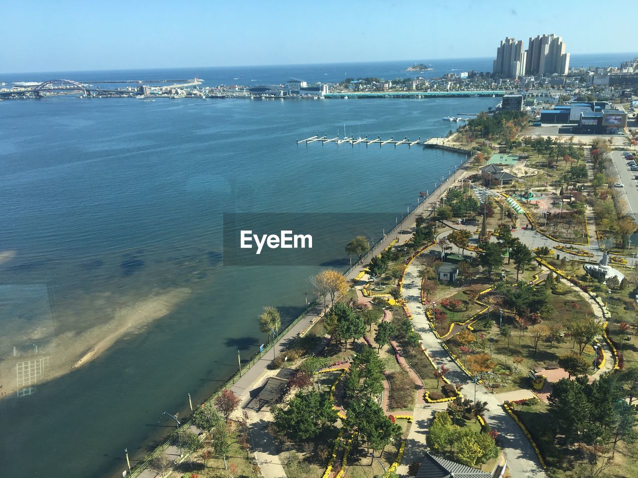 High angle view of buildings by sea against sky