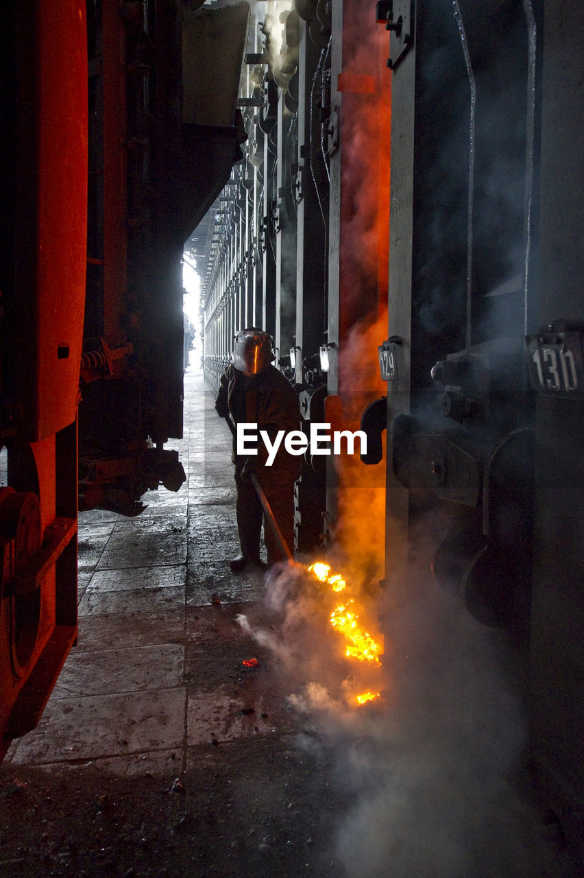 Manual worker molting iron in factory