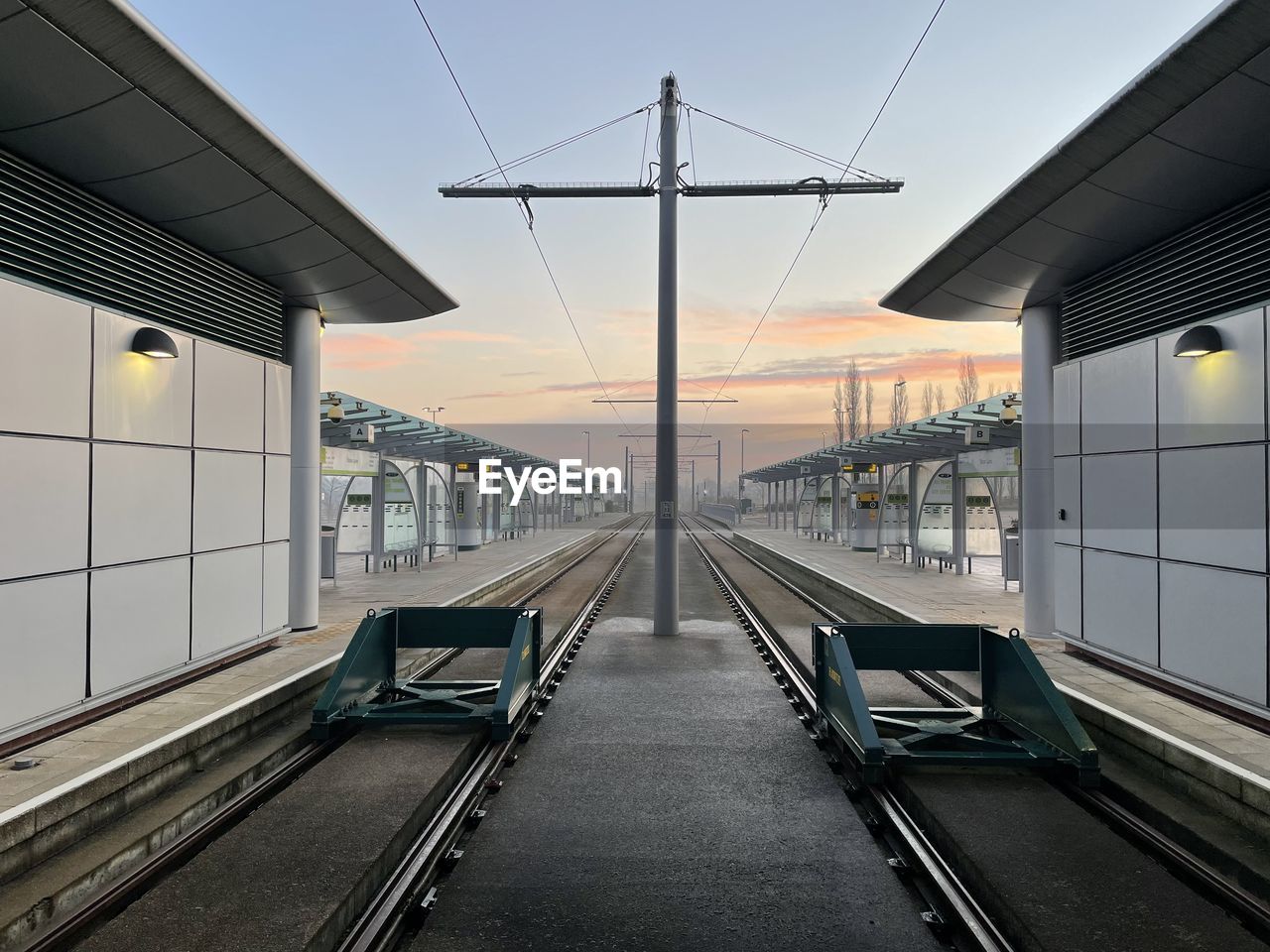 transport, transportation, architecture, rail transportation, public transport, travel, built structure, railroad track, track, mode of transportation, railroad station, sky, no people, city, public transportation, railroad station platform, train, outdoors, nature, technology, station, business