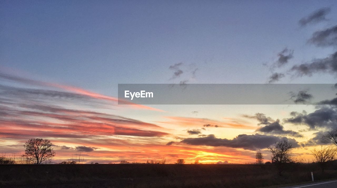 Scenic view of landscape against sky at sunset