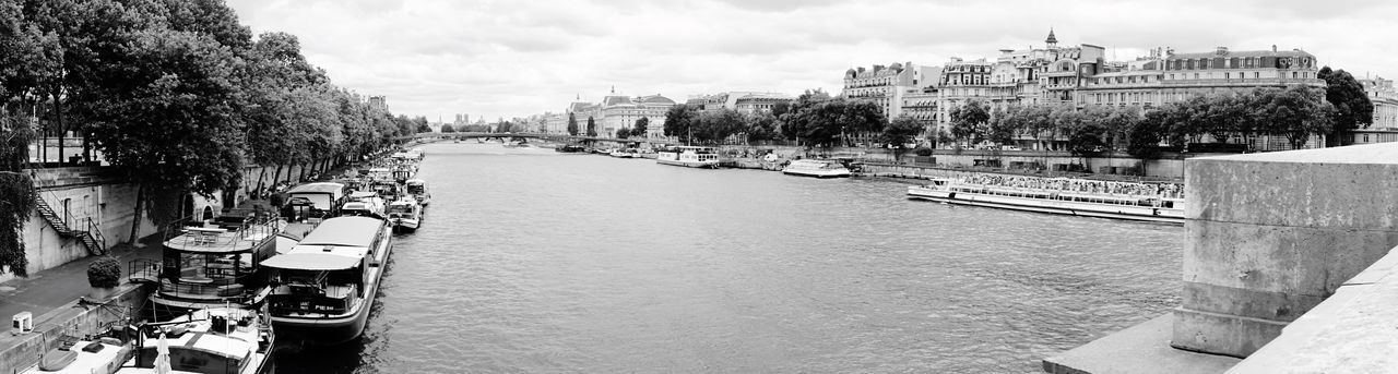 Panoramic view of buildings against cloudy sky