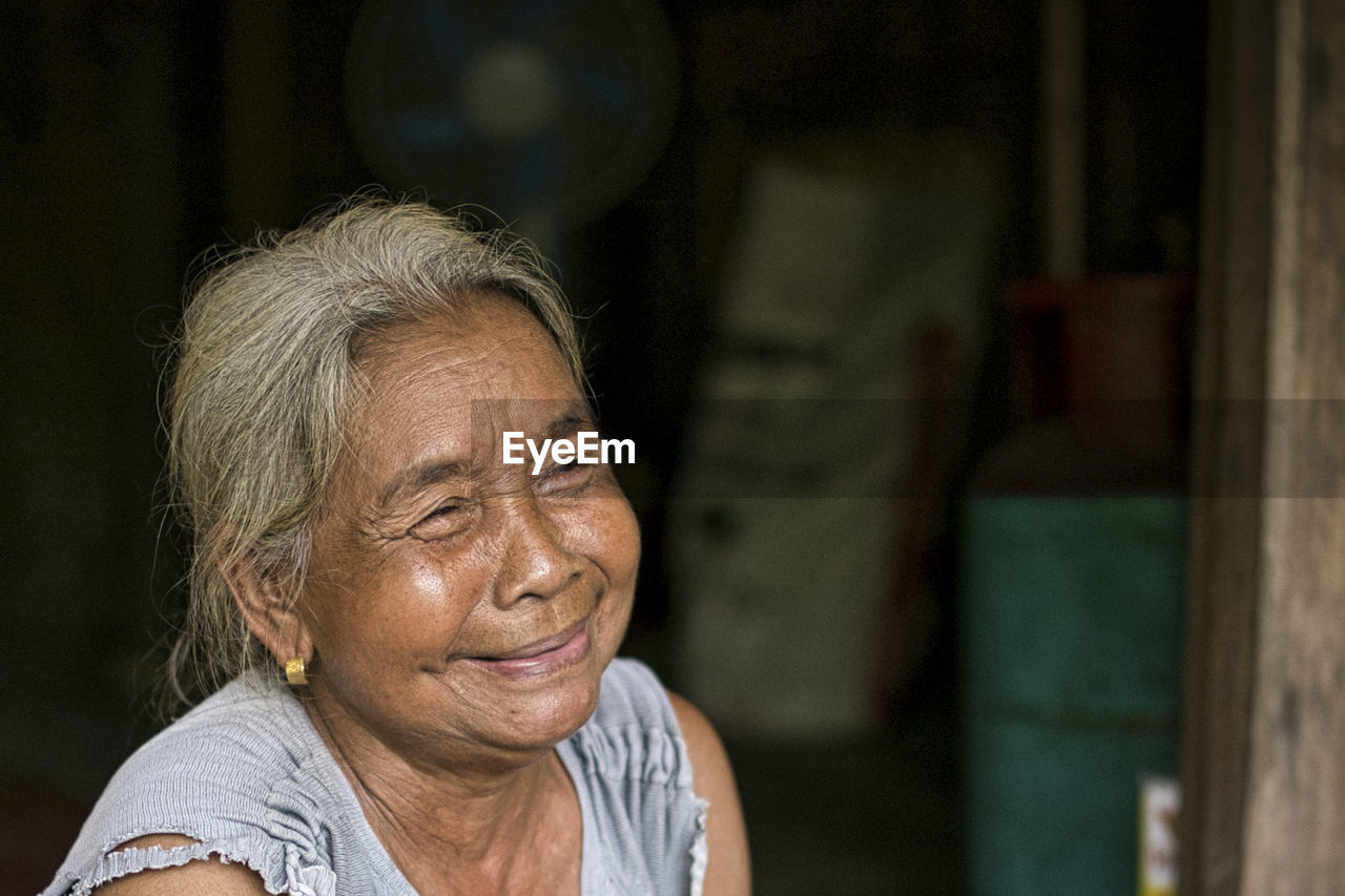 A close-up of a single indigenous woman smiling