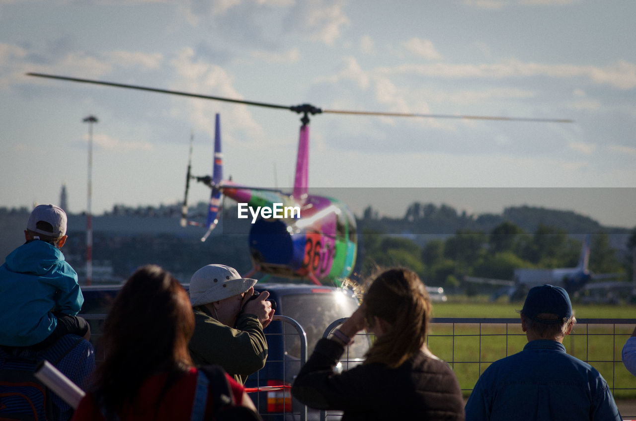 REAR VIEW OF PEOPLE IN THE SKY