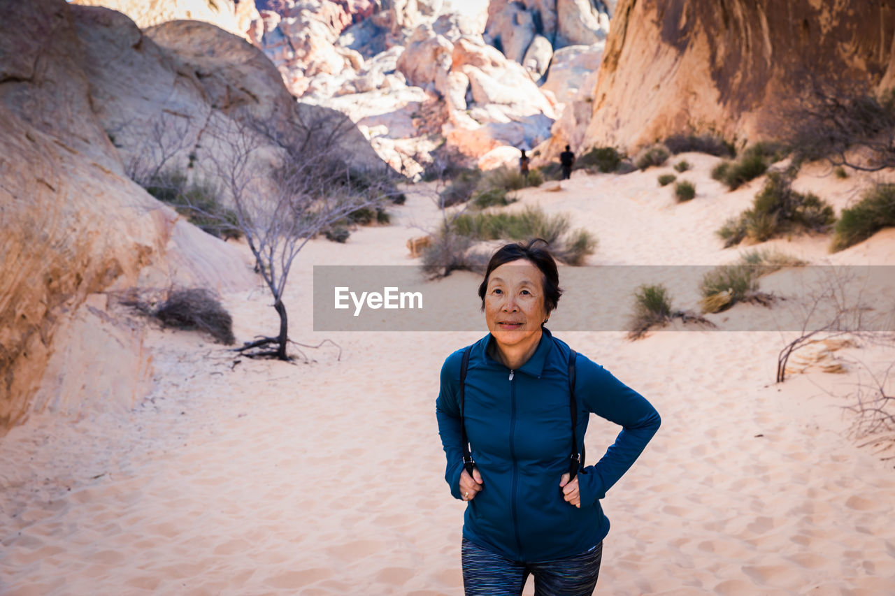 Senior asian woman hiking in the desert landscape