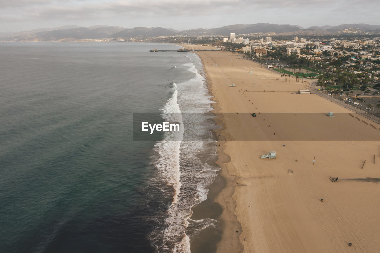 Beautiful wide view over manhattan beach in california with waves crashing onto beach