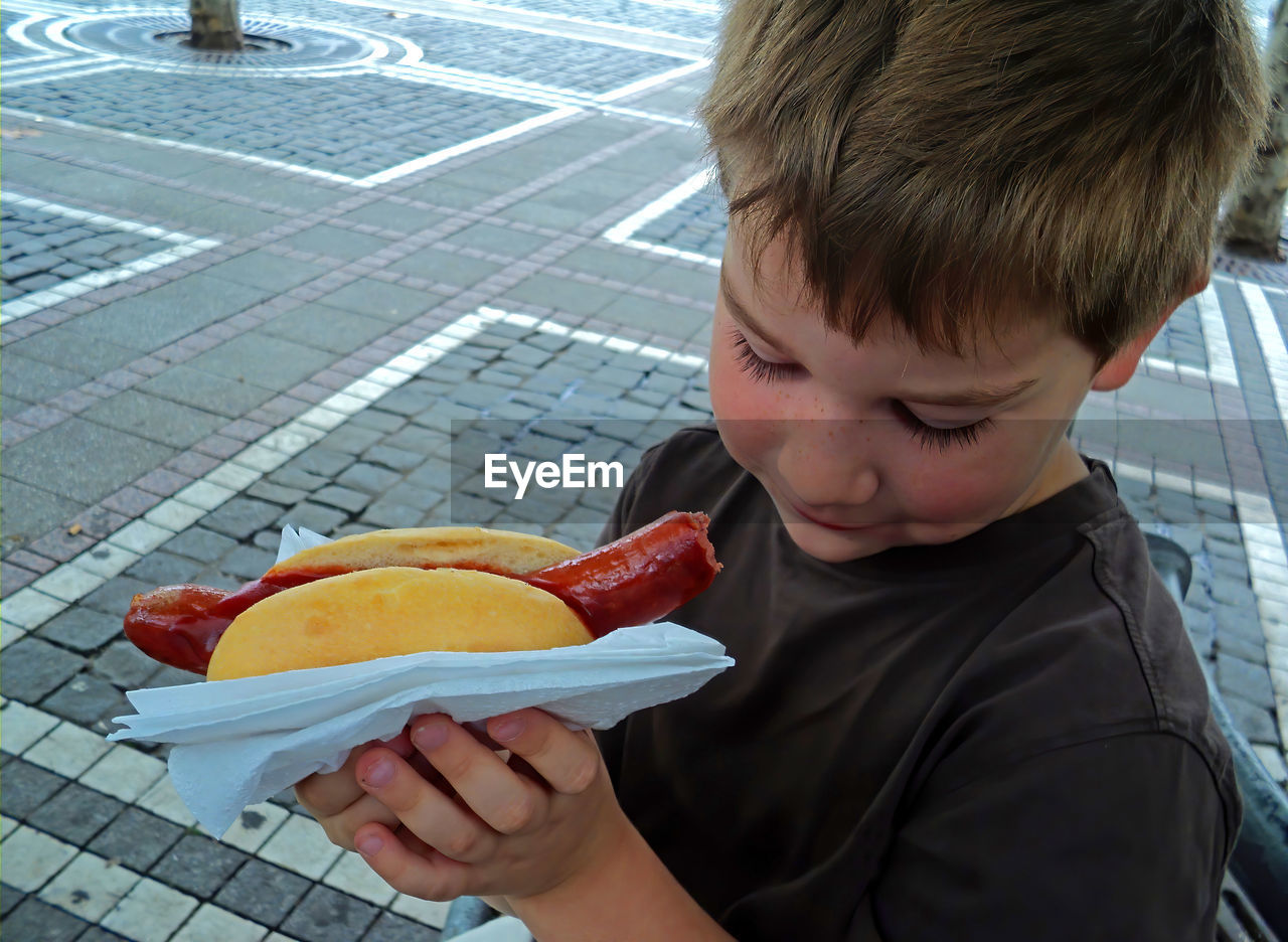 Close-up of boy holding hotdog