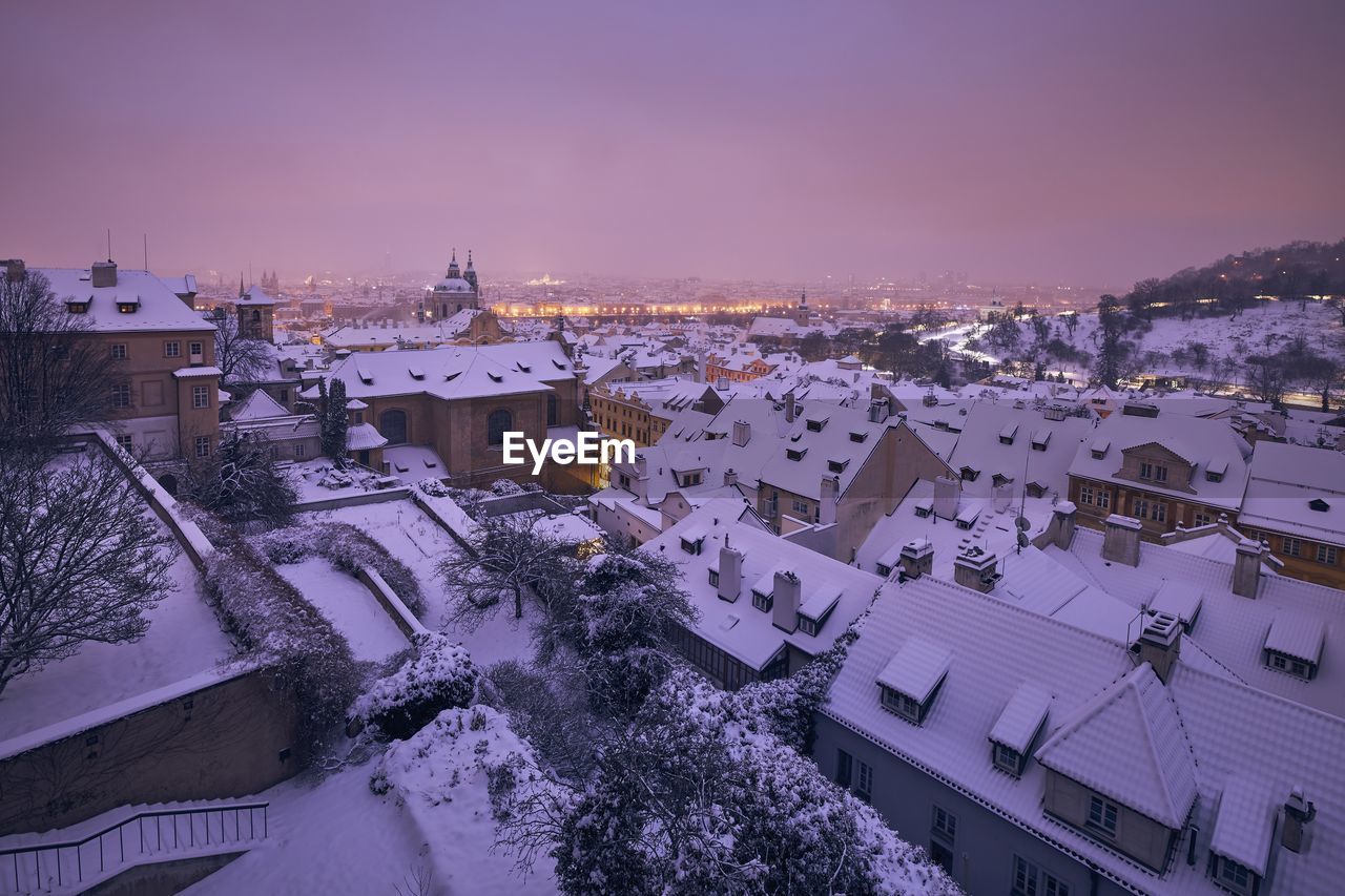 Prague in winter. view of snowy roofs of lesser town at night.