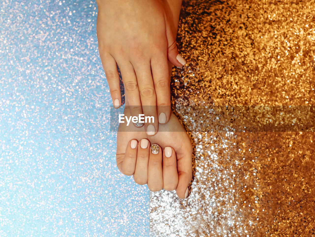 Cropped hands of woman with glitter