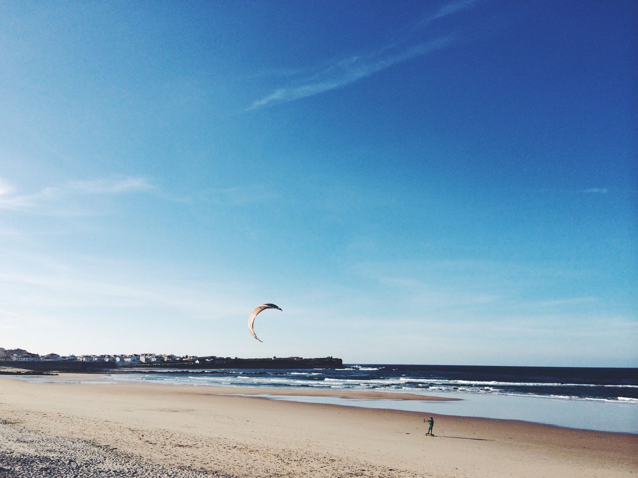 Scenic view of beach against blue sky