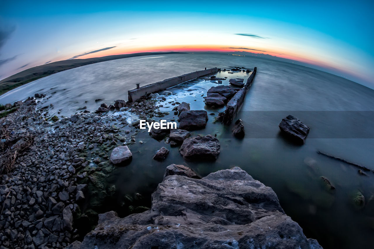 Scenic view of sea against sky at sunset